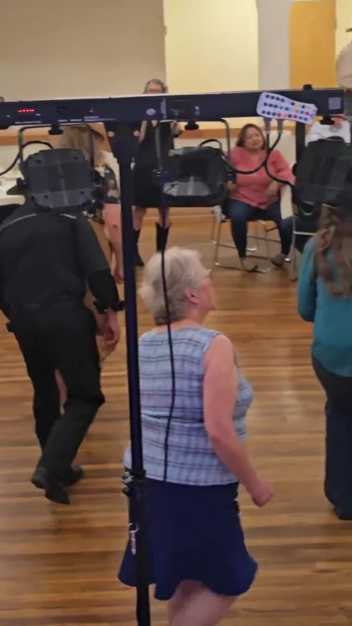 Guests doing a line dance together on a packed floor
