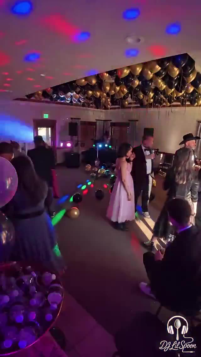 Guests dancing under a full lighting rig at a 30th anniversary party